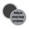 Grey magnet with the text 'Reading can seriously damage your ignorance.' printed in black.