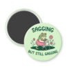 Magnet with a frog character and text 'Sagging but still gagging' on a light green background.
