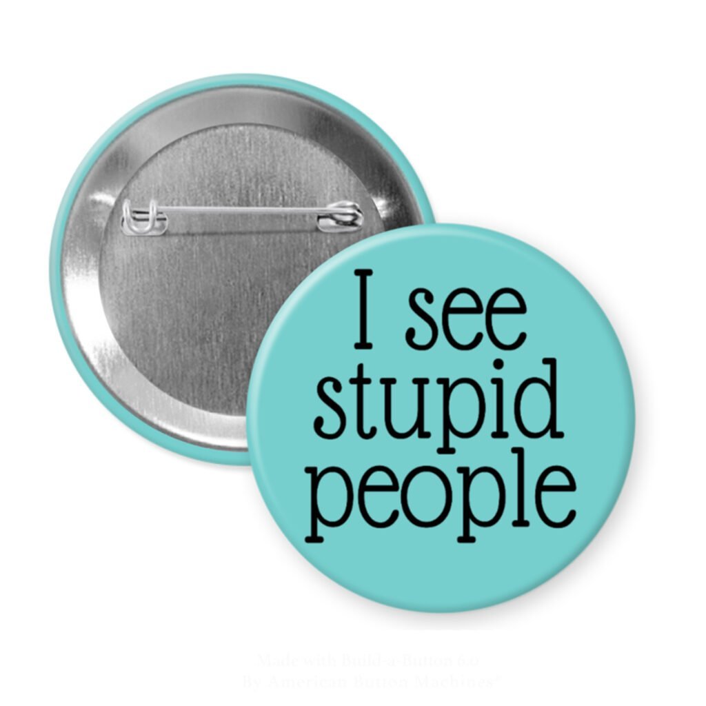 Blue pinback button with the text 'I see stupid people' printed in black.