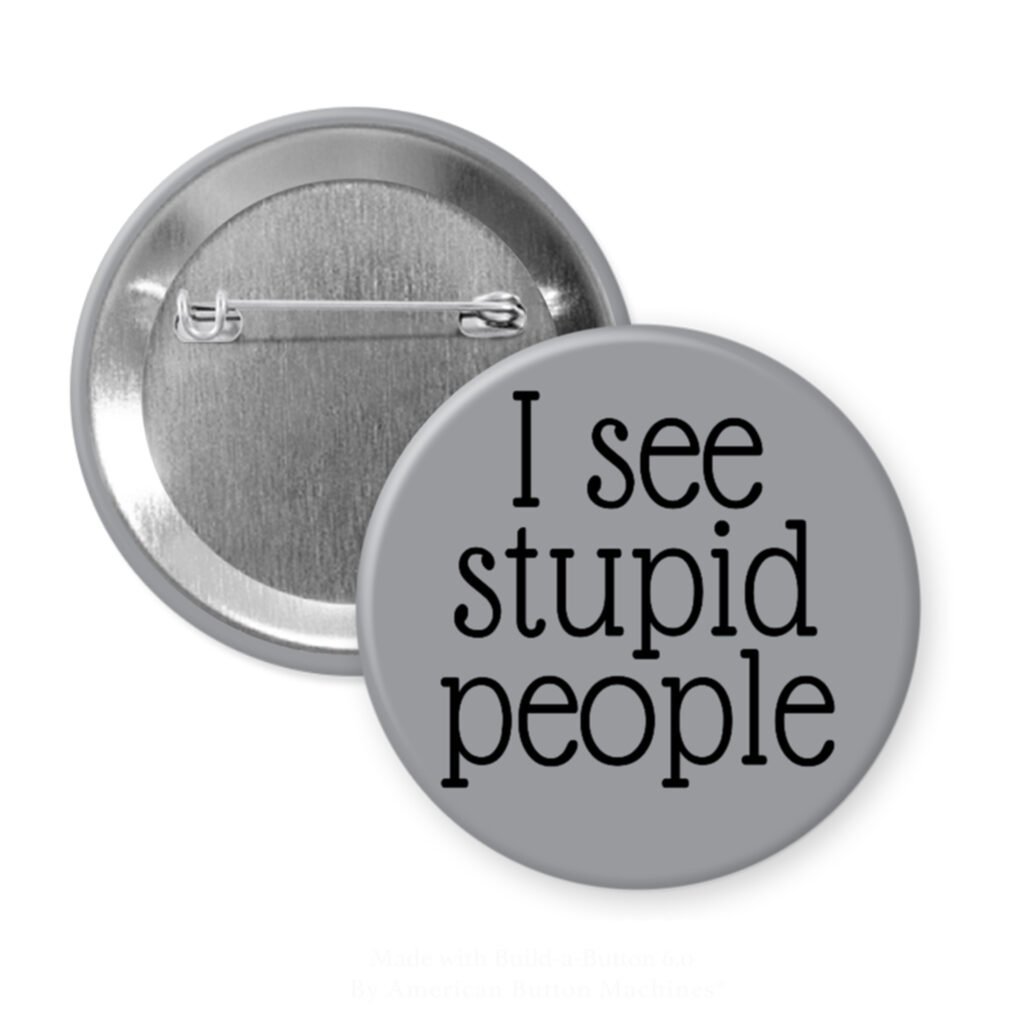Grey pinback button with the text 'I see stupid people' printed in black.