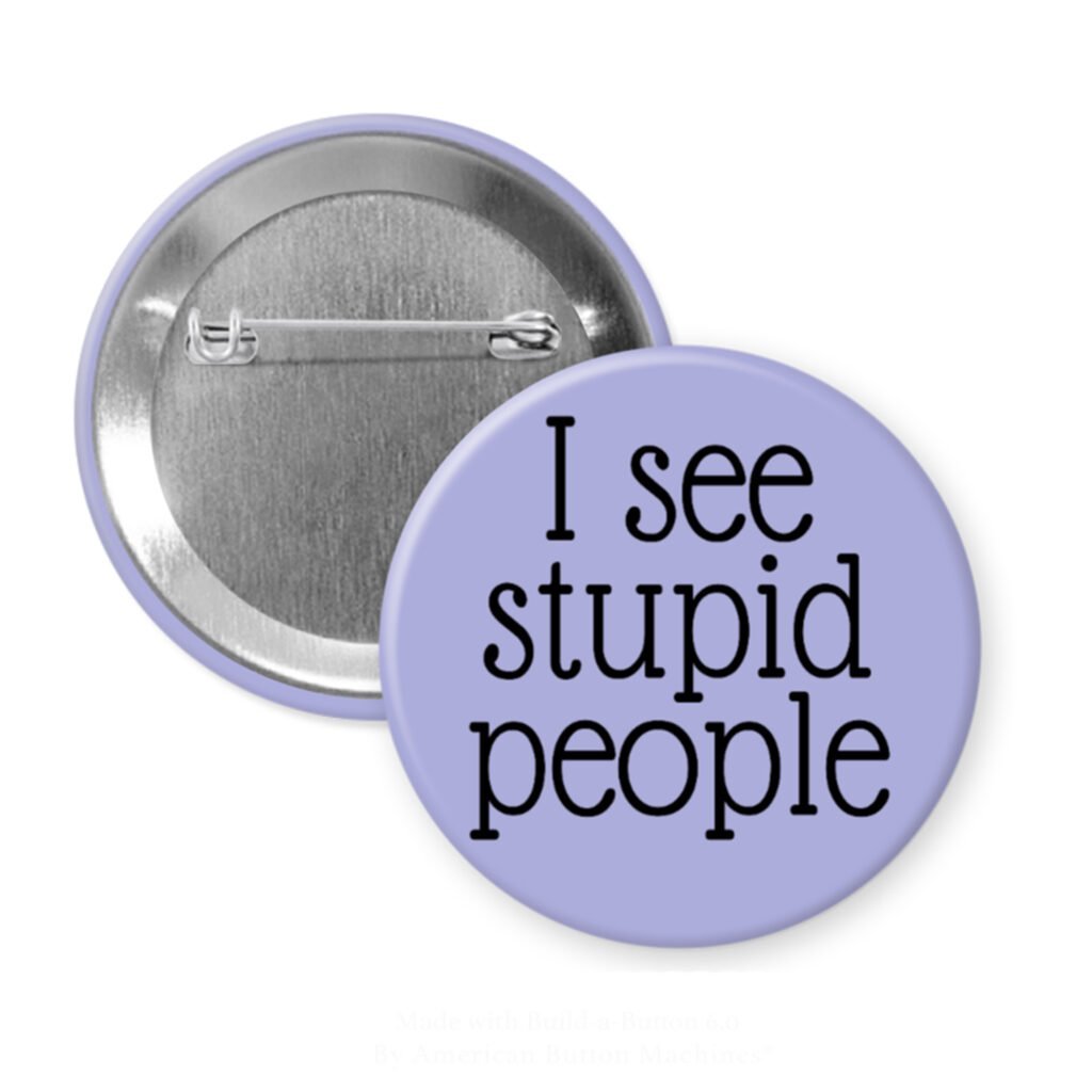 Purple pinback button with the text 'I see stupid people' printed in black.