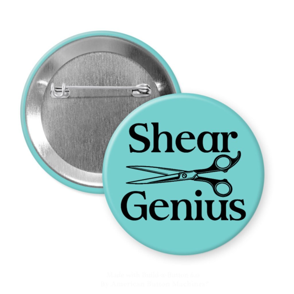Blue pinback button with an image of haircutting shears and the text 'Shear Genius' printed in black.