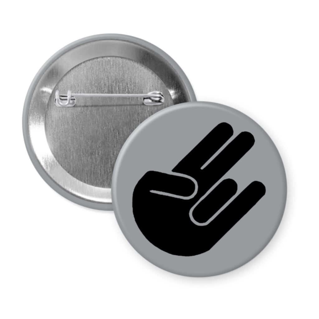 Grey pinback button with the shocker hand gesture printed in black.