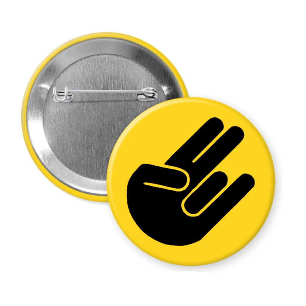 Yellow pinback button with the shocker hand gesture printed in black.