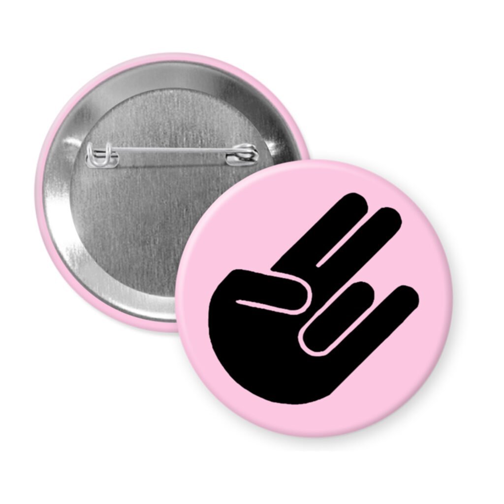 Pink pinback button with the shocker hand gesture printed in black.