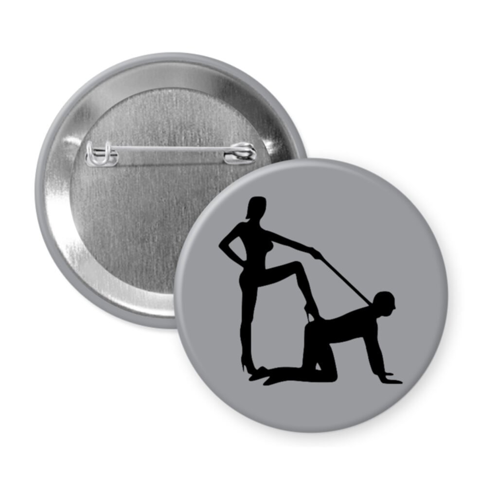 Grey pinback button with silhouette image of a man on his hands and knees and a dominatrix holding his leash.