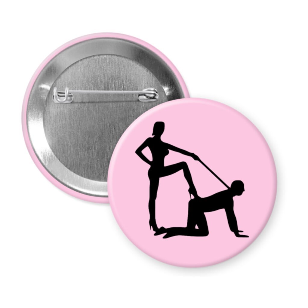 Light pink pinback button with silhouette image of a man on his hands and knees and a dominatrix holding his leash.
