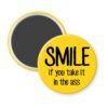 Yellow magnet with the text 'SMILE if you take it in the ass' printed in black.