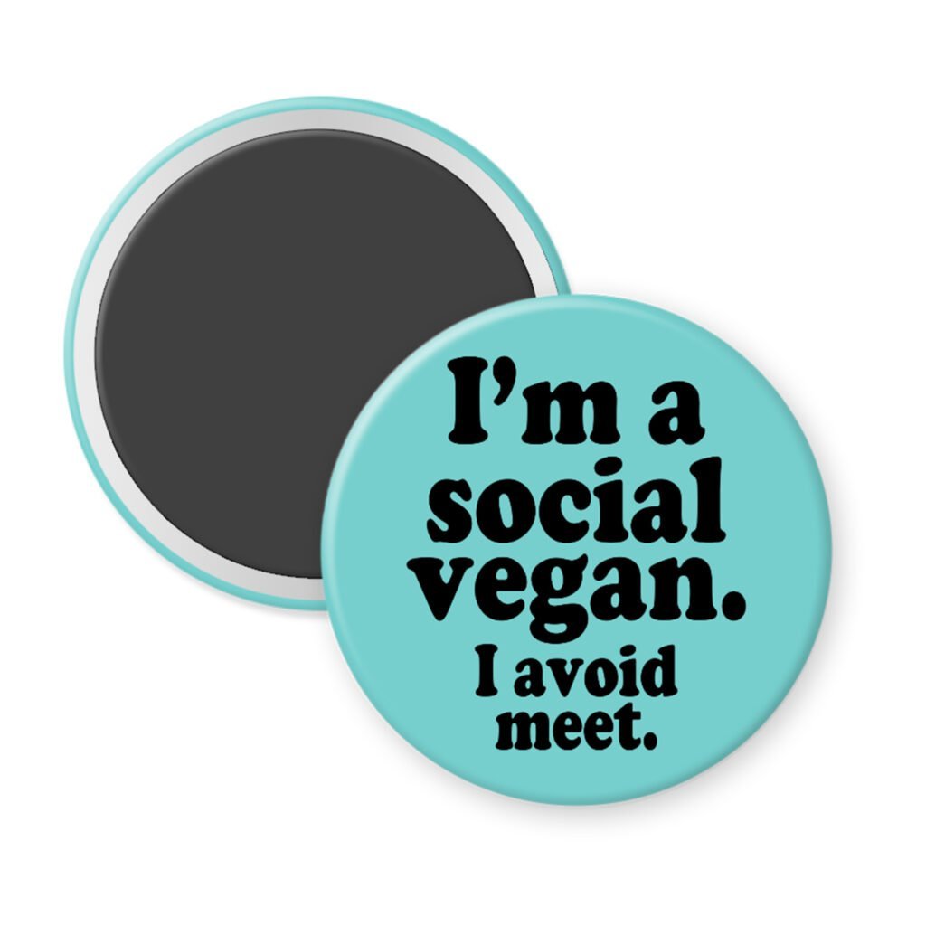 Blue magnet with the text 'I'm a social vegan. I avoid meet.' printed in black.