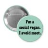 Button badge with text 'I'm a social vegan. I avoid meet.' on a light green background