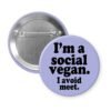 Purple pinback button with the text 'I'm a social vegan. I avoid meet.' printed in black.