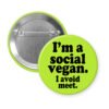 Green pinback button with the text 'I'm a social vegan. I avoid meet.' printed in black.