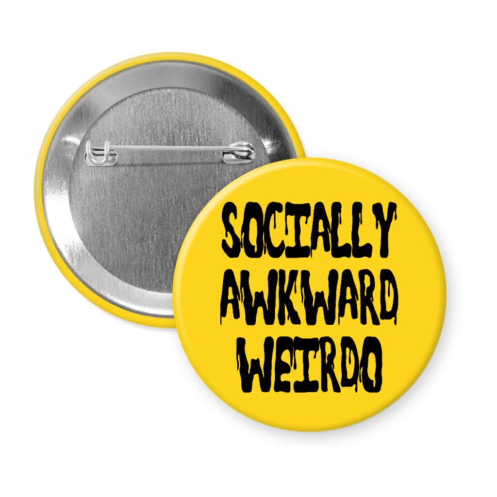 Yellow pinback button with the text 'Socially awkward weirdo' printed in black drippy font.