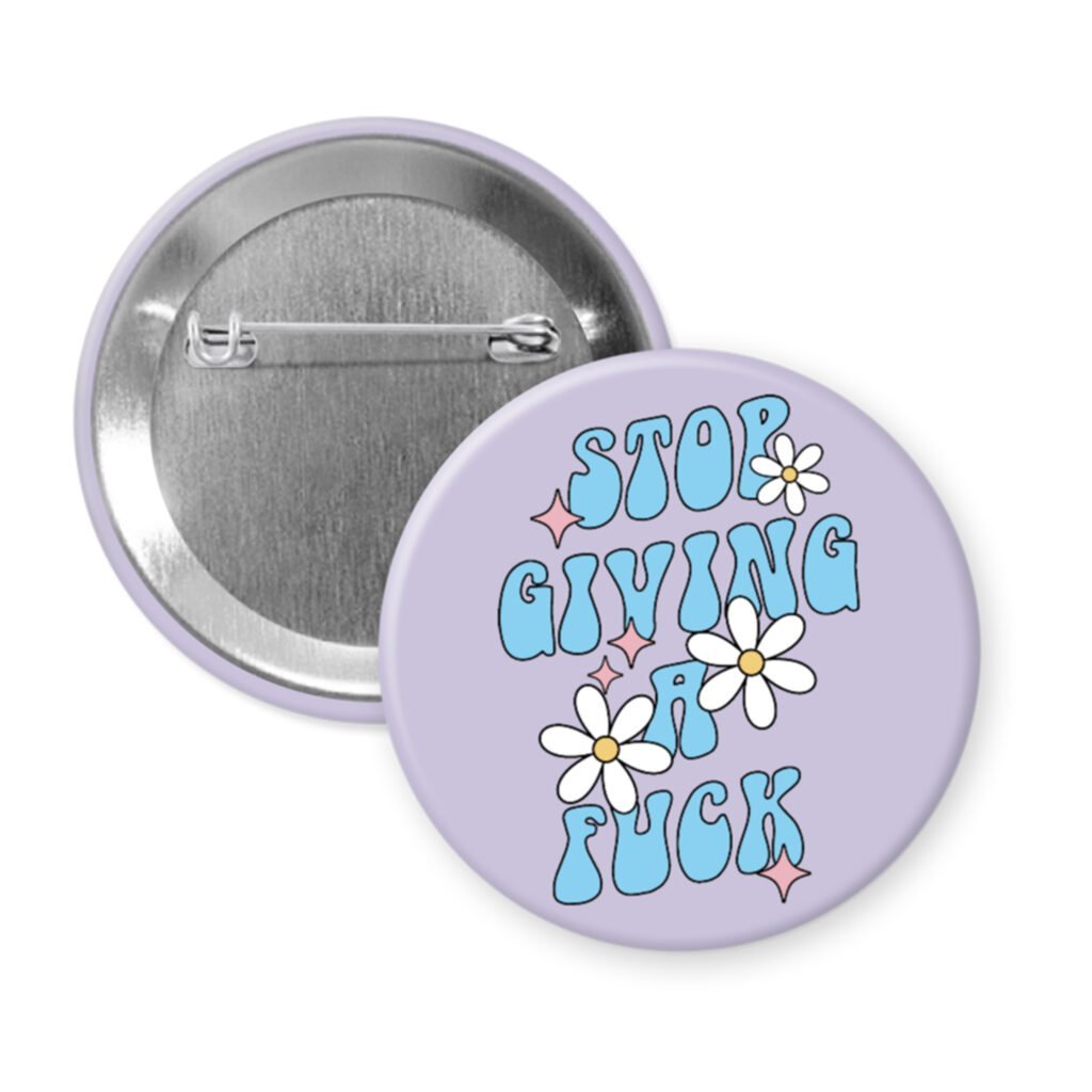Swearing humor button badge with text 'Stop Giving a Fuck' and flowers on a light purple background.
