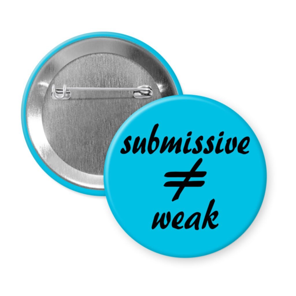Blue pinback button with the text 'submissive ≠ weak' printed in black.