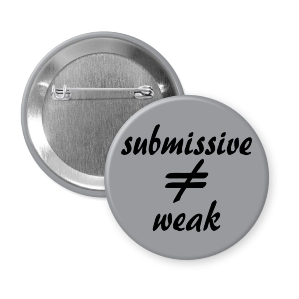 Grey pinback button with the text 'submissive ≠ weak' printed in black.