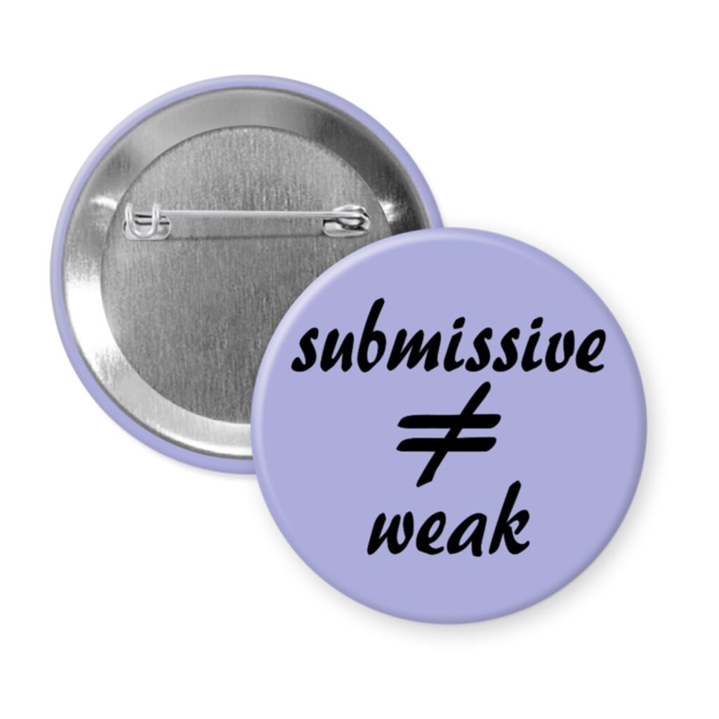 Purple pinback button with the text 'submissive ≠ weak' printed in black.