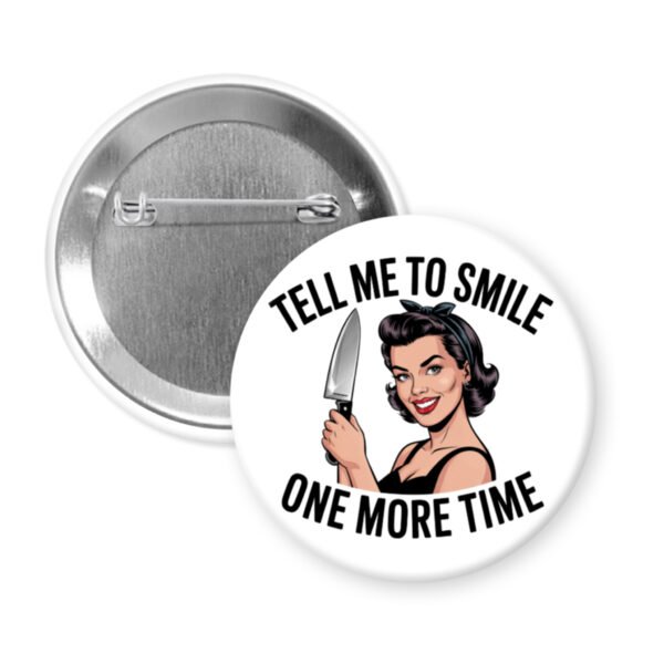 Button with image of a woman holding a knife and the phrase "Tell me to smile one more time"
