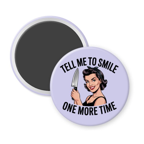 Purple magnet with image of a woman holding a knife and the phrase "Tell me to smile one more time"