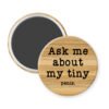 Magnet with text 'Ask me about my tiny penis' on a wooden background