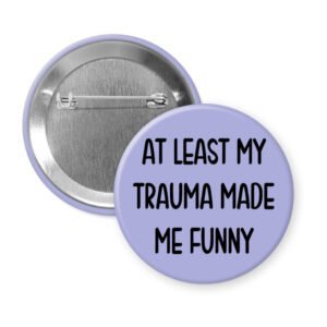 Purple pinback button with the text 'At least my trauma made me funny' printed in black.