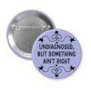 Purple pinback button with the text 'Undiagnosed, but something ain't right' printed in black.