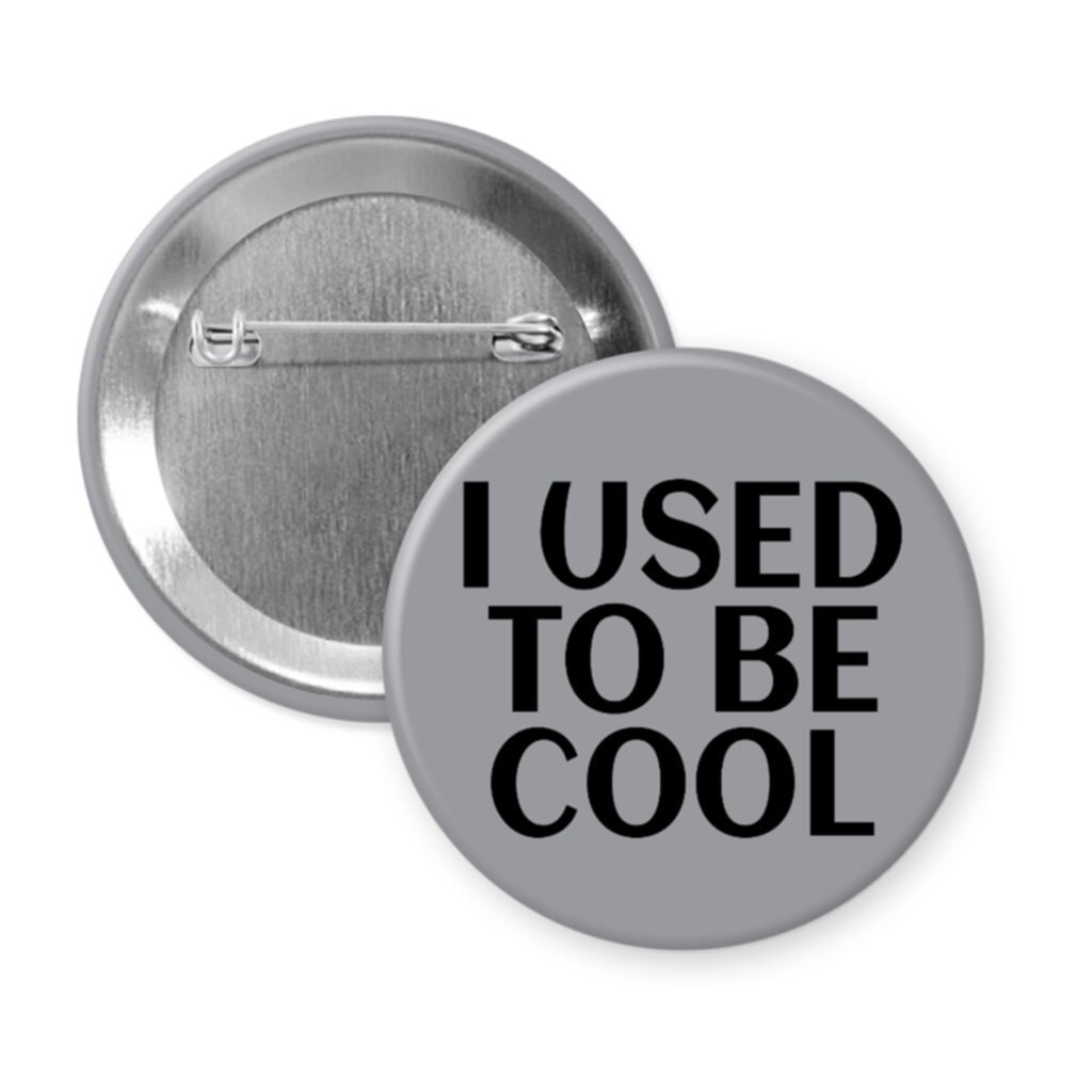 Grey pinback button with the text 'I USED TO BE COOL' printed in black.
