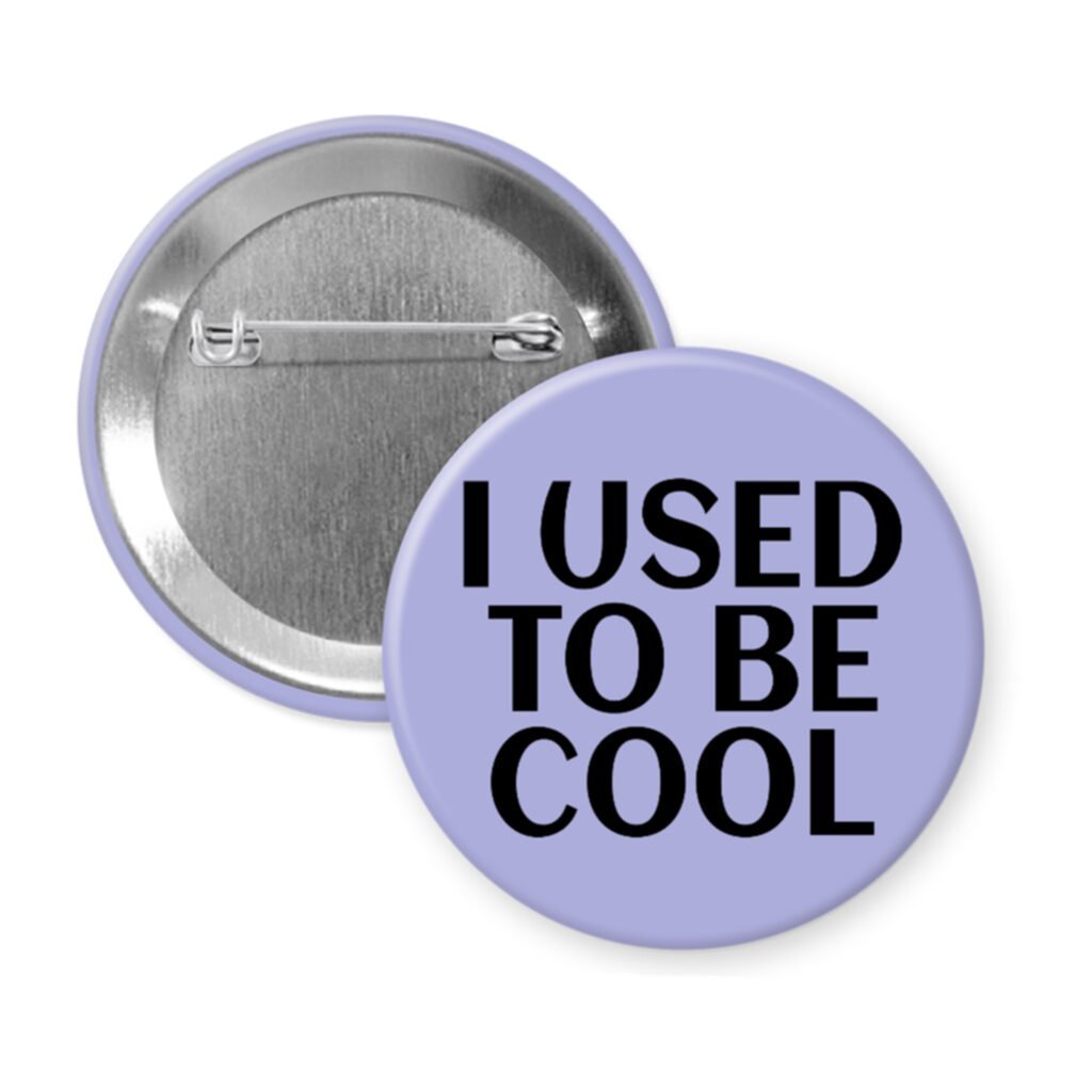 Purple pinback button with the text 'I USED TO BE COOL' printed in black.