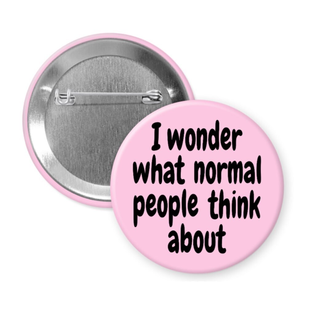 Pink pinback button with the text 'I wonder what normal people think about' printed in black.