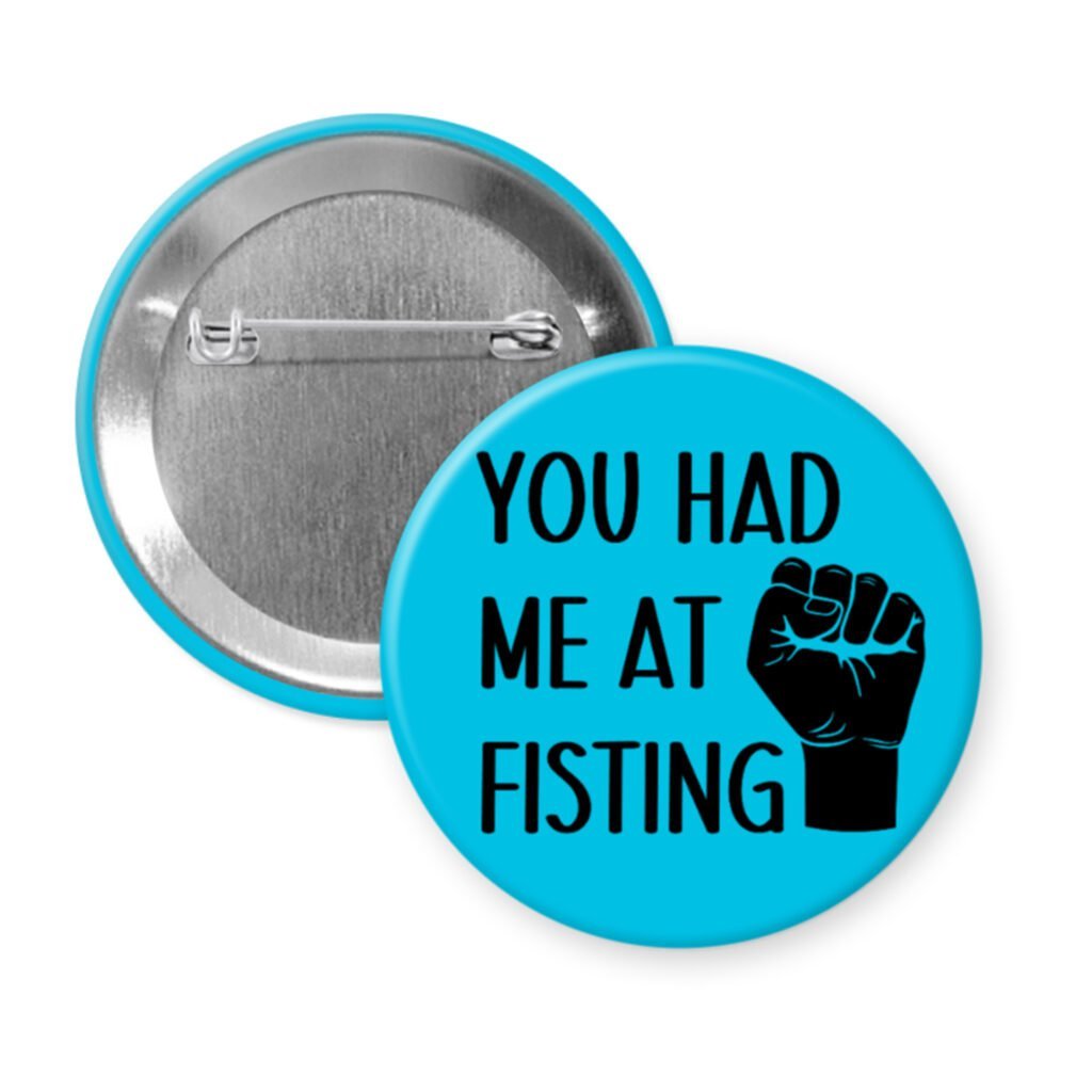 Blue pinback button with an image of a fist and the text 'You had me at fisting'.