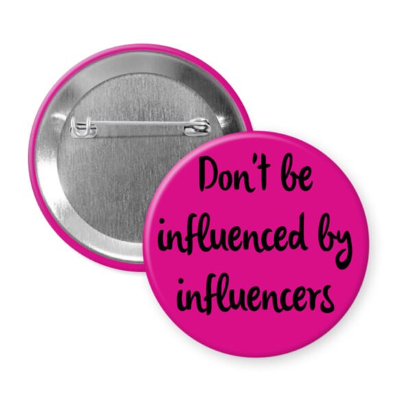 Pink pinback button with the text 'Don't be influenced by influencers' in black text.