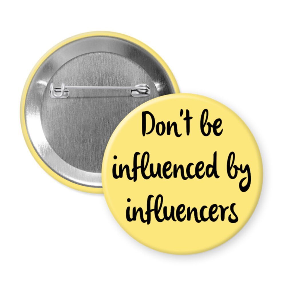 Yellow pin button with the text 'Don't be influenced by influencers' in black text.
