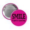 Fuchsia pink button with the text 'SMILE if you're a good boy' printed in black.