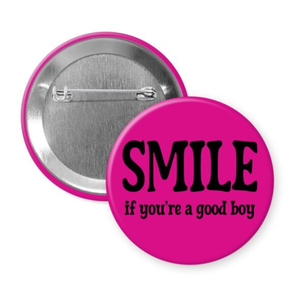 Fuchsia pink button with the text 'SMILE if you're a good boy' printed in black.