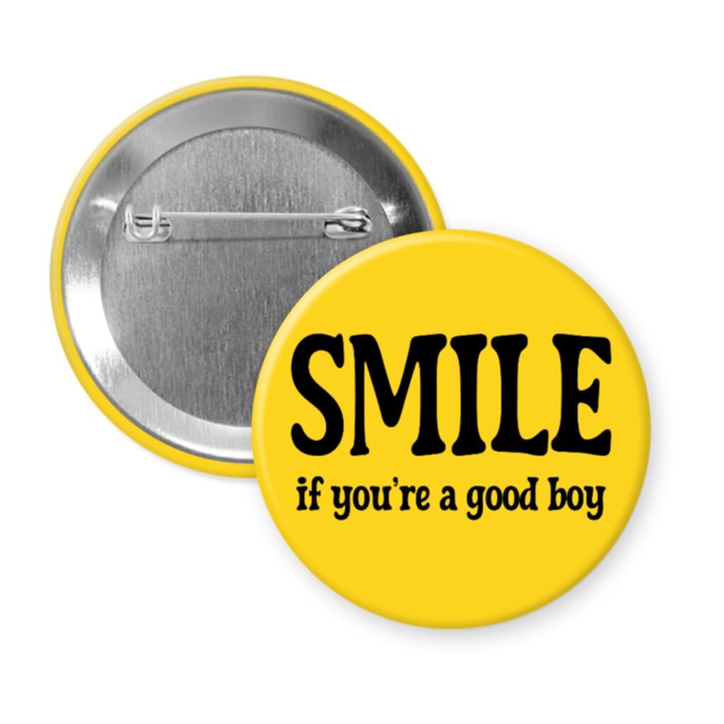 Yellow button with the text 'SMILE if you're a good boy' printed in black.