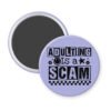 Purple magnet with bold black text reading ‘Adulting is a Scam’ in mixed block and distressed fonts. The design includes a smiley face, star, and flower icons, with a checkerboard stripe along the bottom.