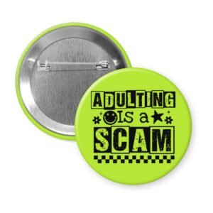Green pinback button with bold black text reading ‘Adulting is a Scam’ in mixed block and distressed fonts. The design includes a smiley face, star, and flower icons, with a checkerboard stripe along the bottom.
