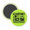Green magnet with bold black text reading ‘Adulting is a Scam’ in mixed block and distressed fonts. The design includes a smiley face, star, and flower icons, with a checkerboard stripe along the bottom.