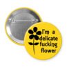 Yellow pinback button with image of a flower and the text 'I'm a delicate fucking flower' printed in black.