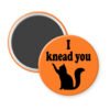 Orange magnet with silhouette of a cat and the text 'I knead you.'