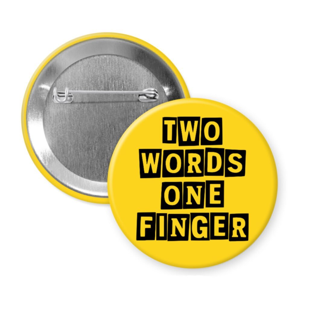Yellow pinback button with the text 'TWO WORDS ONE FINGER' printed in black stencil font.