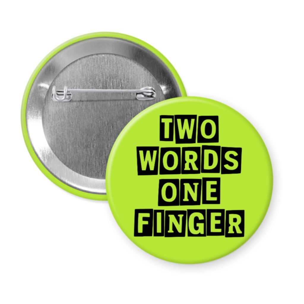Green pinback button with the text 'TWO WORDS ONE FINGER' printed in black stencil font.