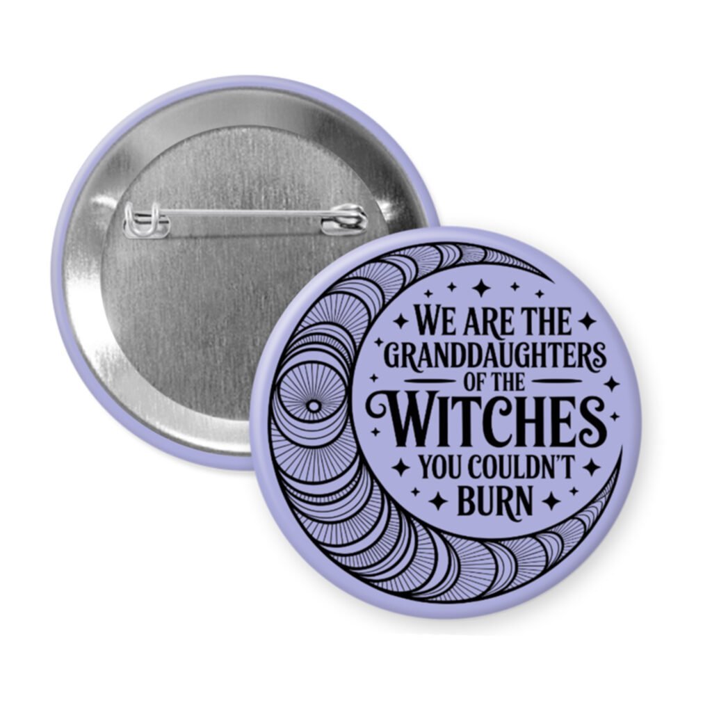 Purple pinback button with image of a line art moon and the text 'We are the granddaughters of the witches you couldn't burn' printed in black.
