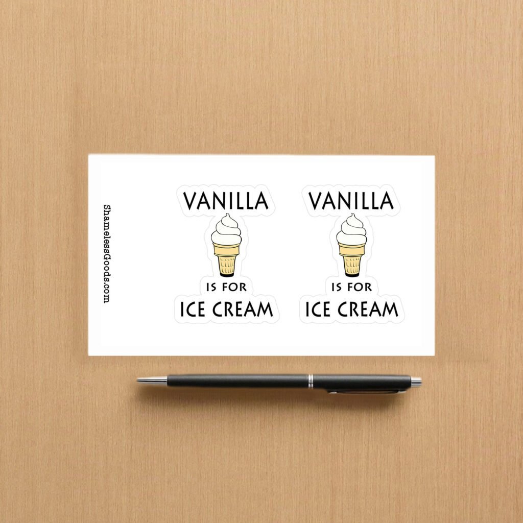Sticker sheet on a wooden surface beside a black pen, featuring two identical designs showing a vanilla ice cream cone illustration with the phrase Vanilla is for ice cream in bold black text. Vertical branding text on the left reads ShamelessGoods.com.