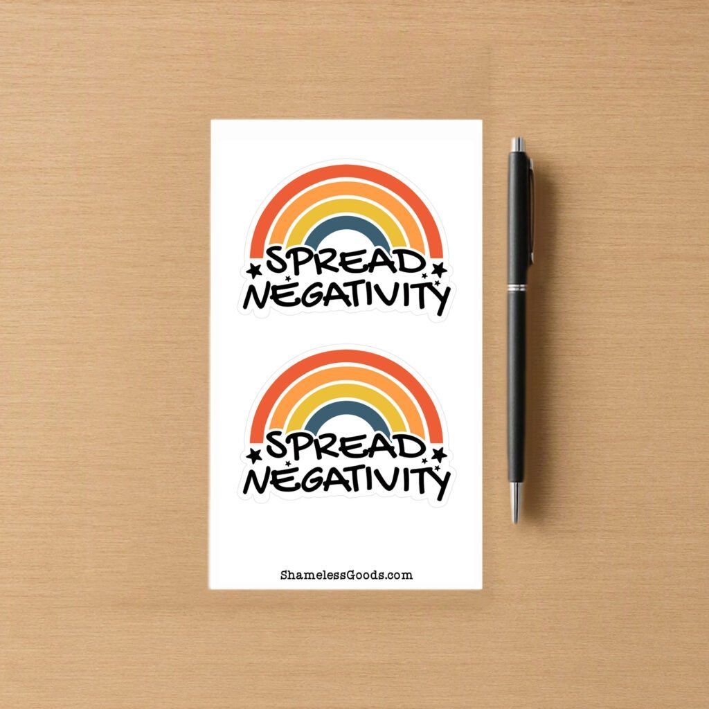 Sticker sheet with two colorful designs showing a retro rainbow with orange, yellow, and blue stripes and the bold text Spread Negativity with small stars.