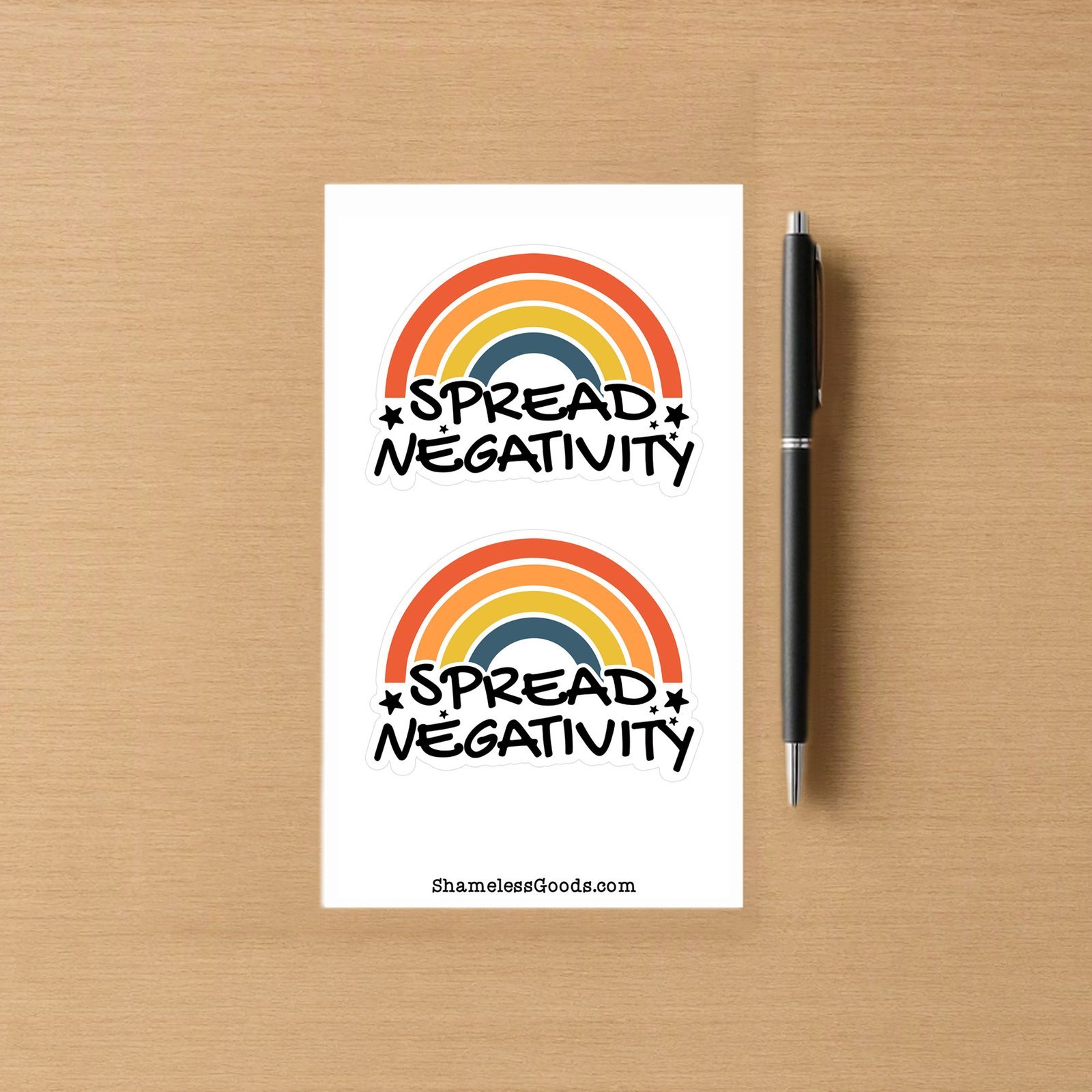 Sticker sheet with two colorful designs showing a retro rainbow with orange, yellow, and blue stripes and the bold text Spread Negativity with small stars.