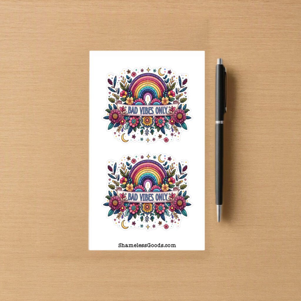 Sticker sheet with two colorful designs showing a rainbow surrounded by flowers, stars, and moons with the text Bad Vibes Only across the center.