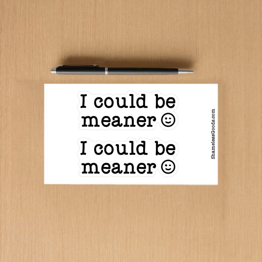 Sticker sheet with two designs showing bold black text I could be meaner followed by a smiling face symbol on a white background.