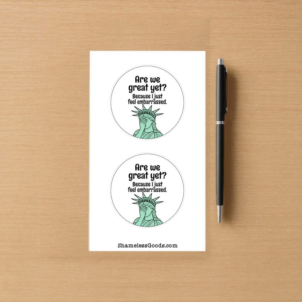 Sticker sheet with two round designs showing the Statue of Liberty facepalming under the text Are We Great Yet Because I just feel embarrassed.