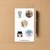 Sticker sheet with five dark humor designs including a sarcastic witch, grumpy cat, Liberty figure, tired character, and a subtle political Are We Great Yet design.
